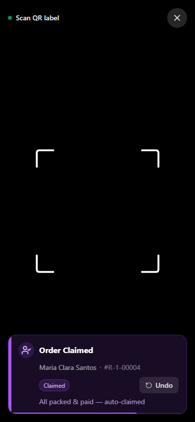 QR scanner showing an auto-claimed order — all loads packed and paid