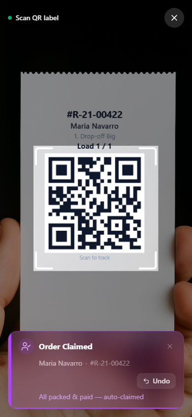 Scan result toast showing an auto-claimed order, all loads packed and paid