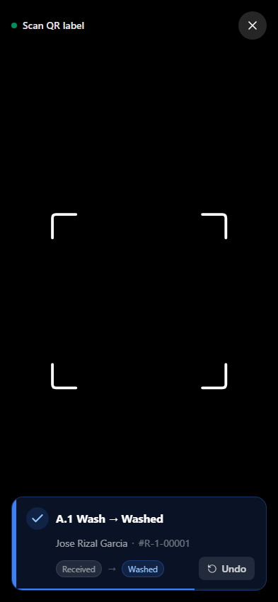 QR scanner showing a successful scan — Regular Wash advanced from Received to Washed